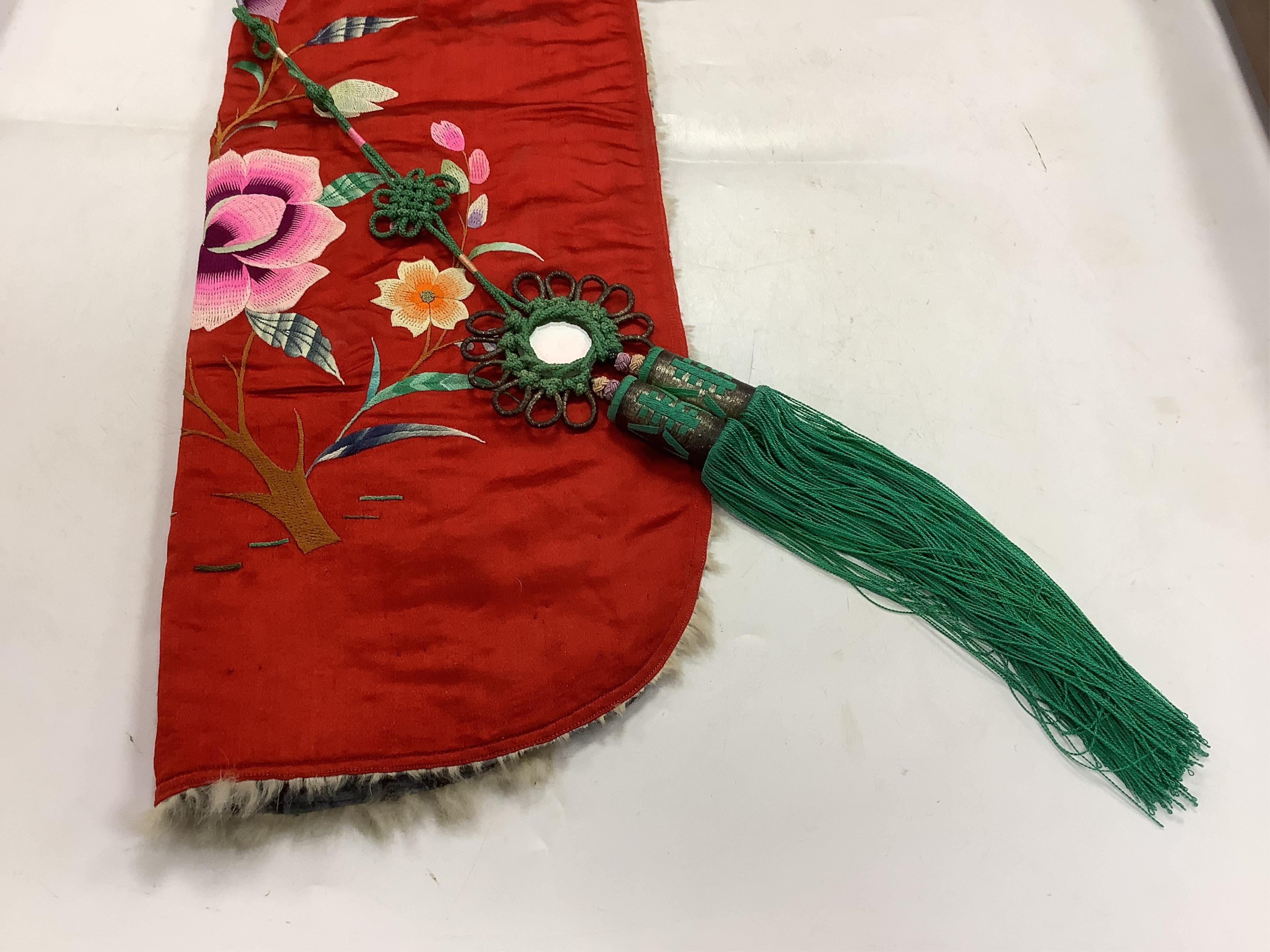 A 20th century possibly Miao, child’s multi coloured silk embroidered and padded winter hood, with fur trim and ornate tasselled decoration, 54cm long. Condition - the light green silk edge has worn and has lightly disco